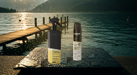 Kabuto Katana Zwei-Phasen-Spülung Milk Therapy und Glanzspray Kokos & Olivenöl auf nassem Stein an einem österreichischen Badesee im Abendlicht